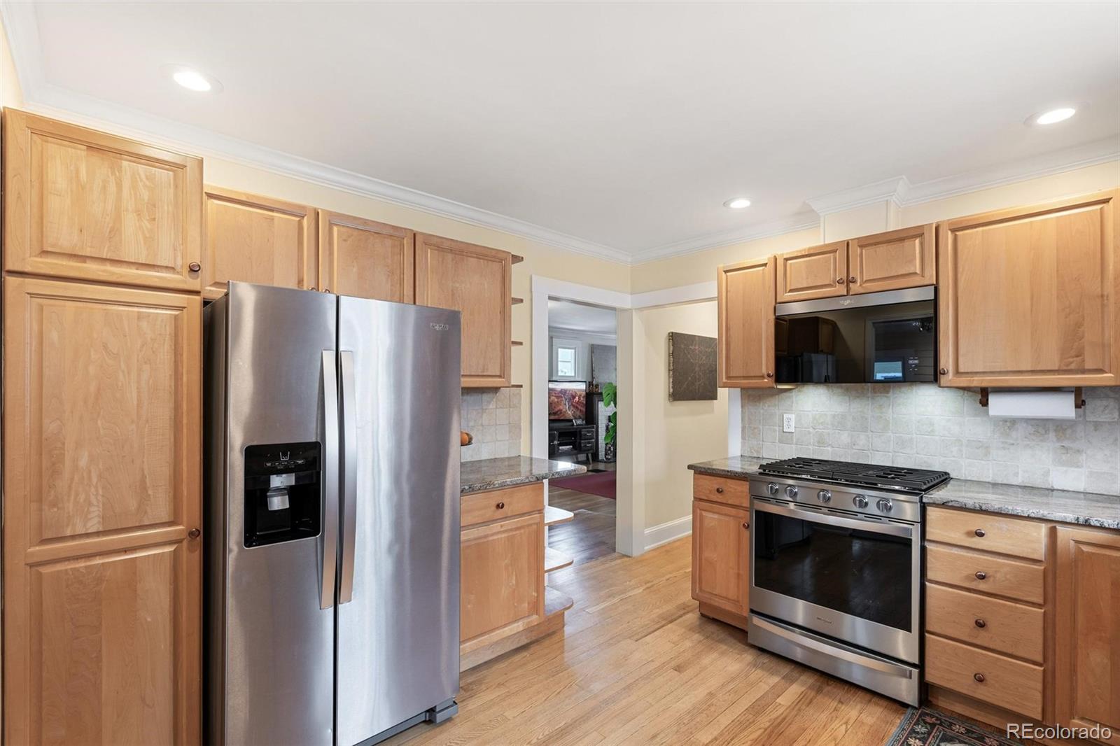 3902 Xavier Street Denver, CO 80212 - Photo 11 of 27 a kitchen with stainless steel appliances a refrigerator stove and microwave