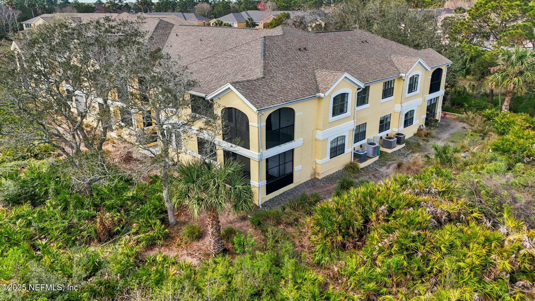 2102 Vista Cove Road St. Augustine, FL 32084 - Photo 37 of 40 an aerial view of a house with a yard and large trees