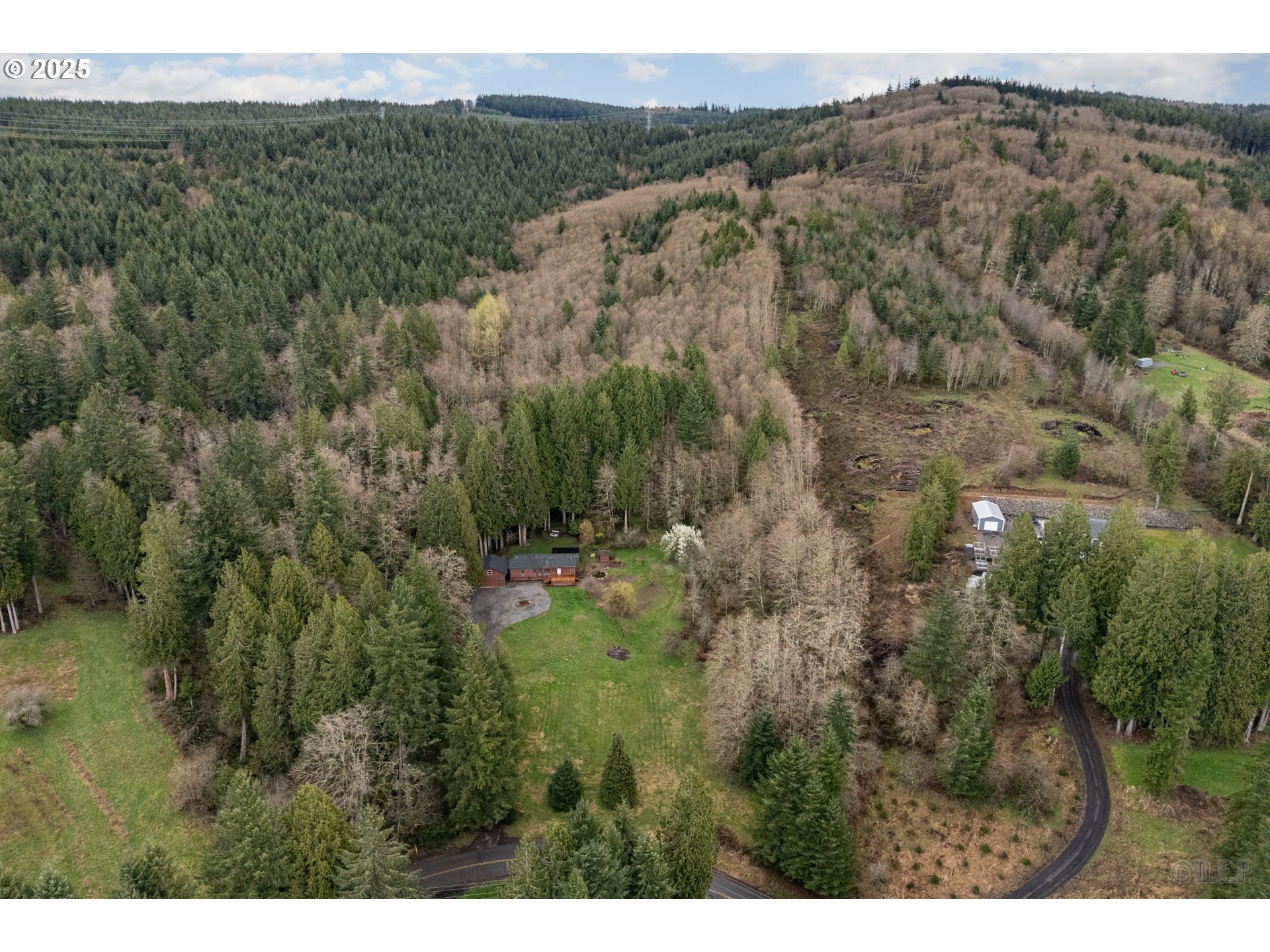 72482 Beaver Springs Road Rainier, OR 97048 - Photo 23 of 27 a view of a lush green forest with trees and some houses