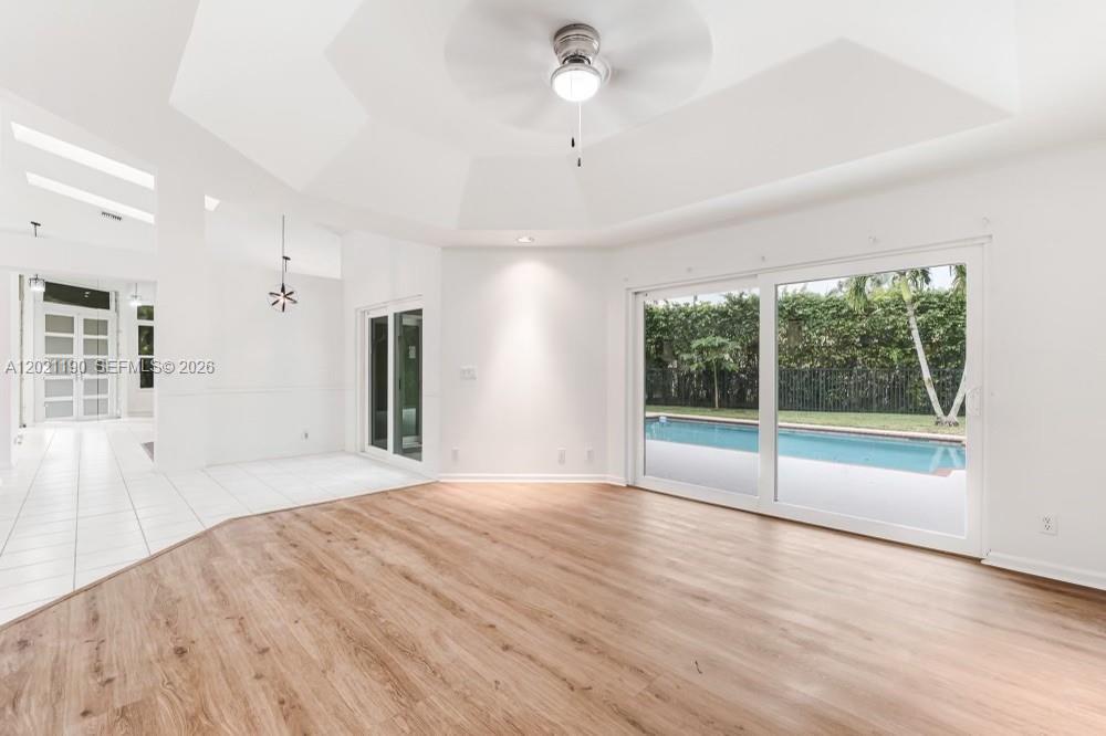 814 Heron Road Weston, FL 33326 - Photo 9 of 27 a view of an empty room with a window and wooden floor