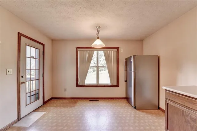 a view of room with window and wooden floor