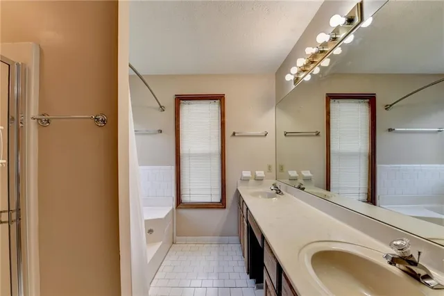 a bathroom with a tub and shower