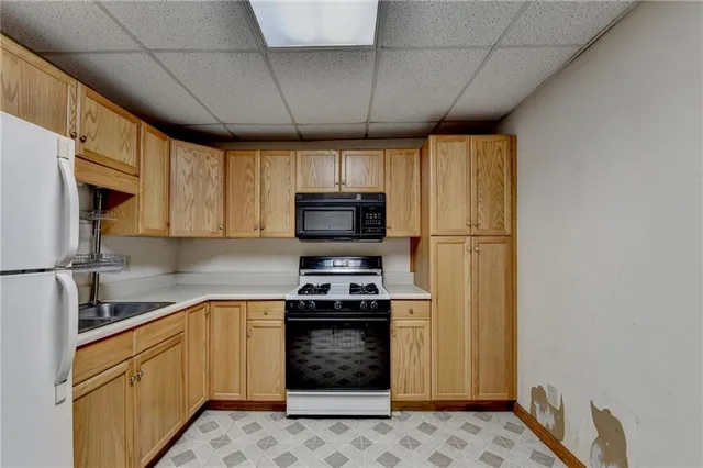 a kitchen with stainless steel appliances a refrigerator stove and microwave