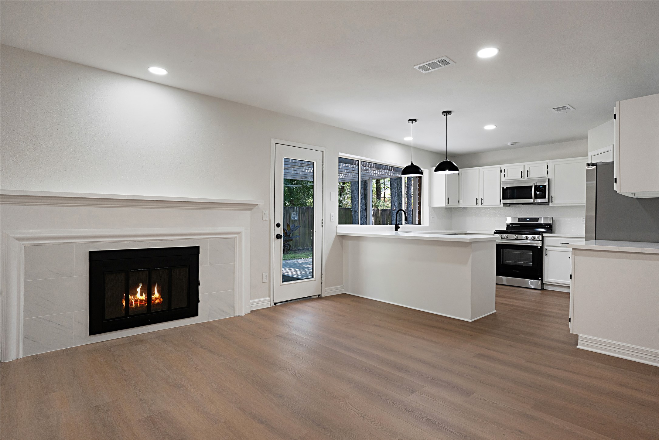 Versatile secondary living space perfect for a den, breakfast nook, reading area, or casual entertainment, open to the kitchen for easy flow.