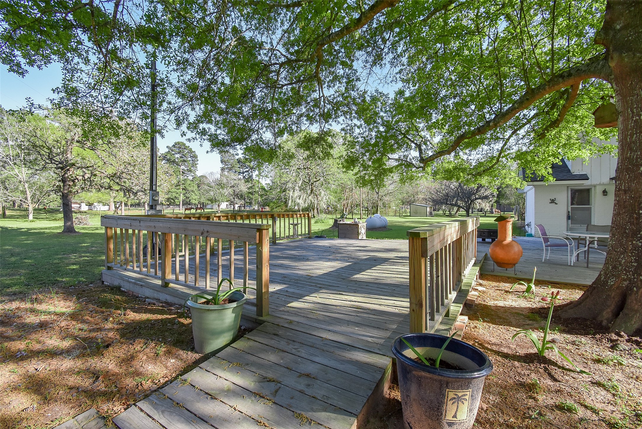 24640 Macedonia Road Hockley, TX 77447 - Photo 44 of 46 a view of a wooden deck with chairs and a yard