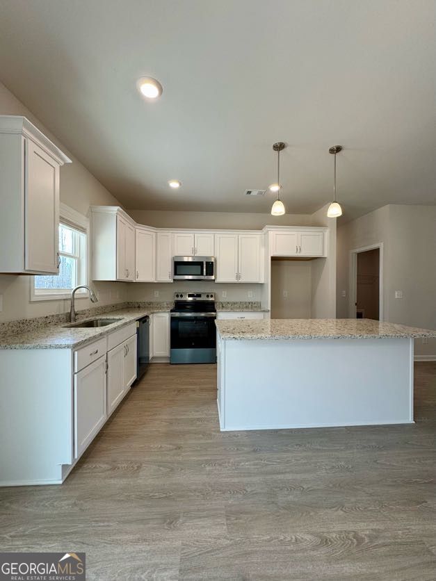 0 Harvest Church Road Clarkesville, GA 30523 - Photo 21 of 33 a large kitchen with stainless steel appliances kitchen island a large counter top and a stove