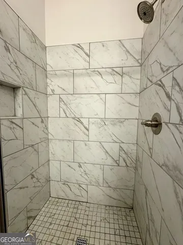 a bathroom with a shower and a toilet