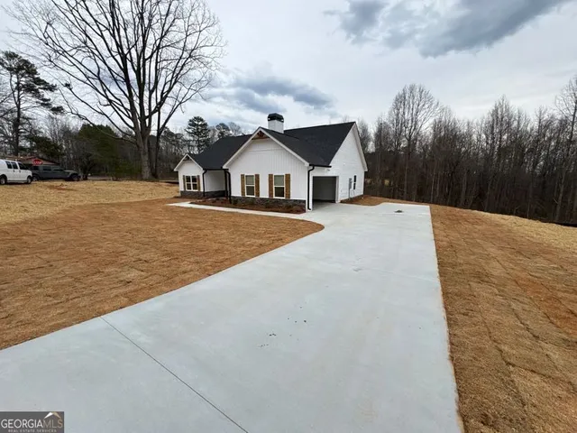 a view of a house with a yard covered in snow