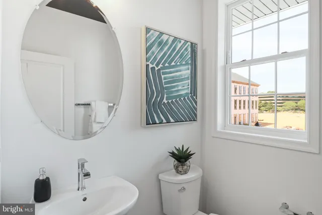a kitchen with a dining table chairs and refrigerator