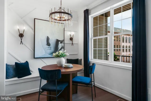a dining room with furniture and wooden floor