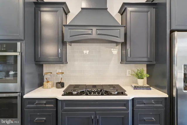 a living room with furniture and large windows