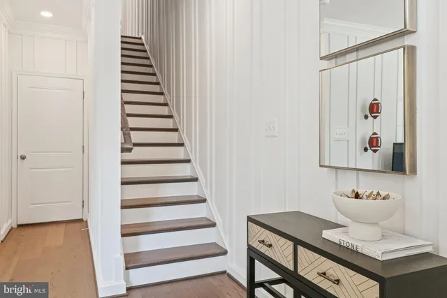 a view of a hallway with wooden floor and entryway