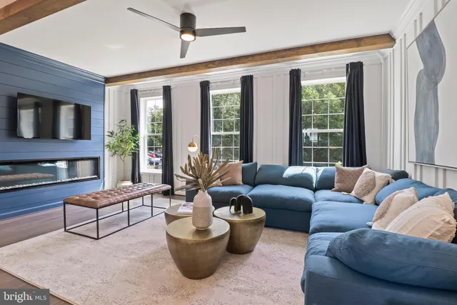 a living room with furniture and wooden floor
