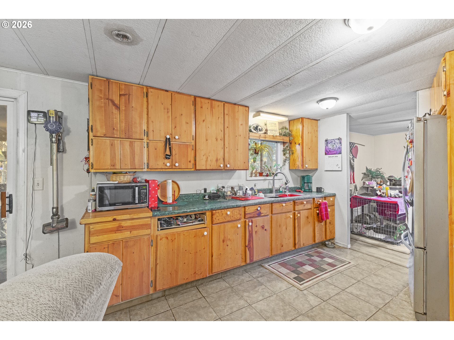 2409 Ireland Road Winston, OR 97496 - Photo 16 of 39 a kitchen with stainless steel appliances kitchen island granite countertop a sink refrigerator and cabinets