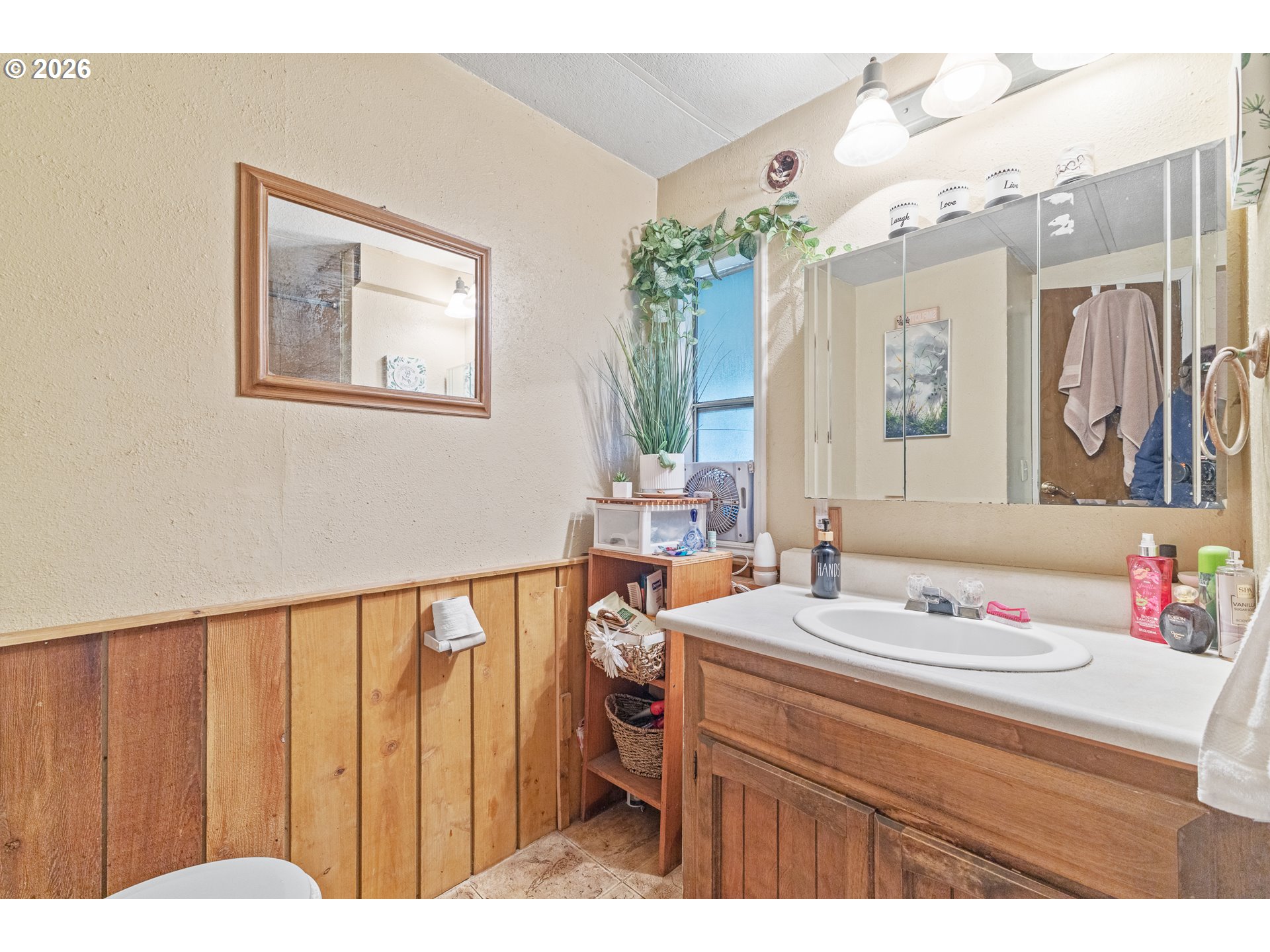 2409 Ireland Road Winston, OR 97496 - Photo 28 of 39 a bathroom with a sink vanity mirror and toilet