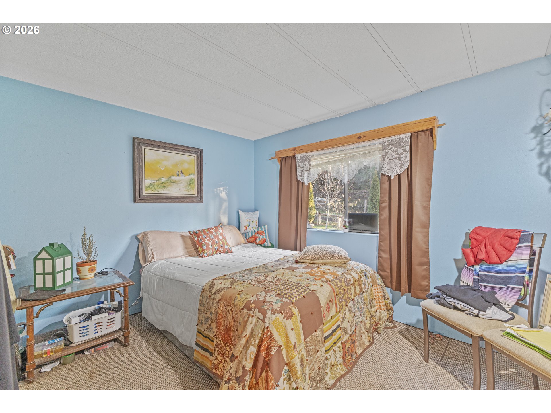 2409 Ireland Road Winston, OR 97496 - Photo 29 of 39 a bedroom with a bed and a painting on the wall