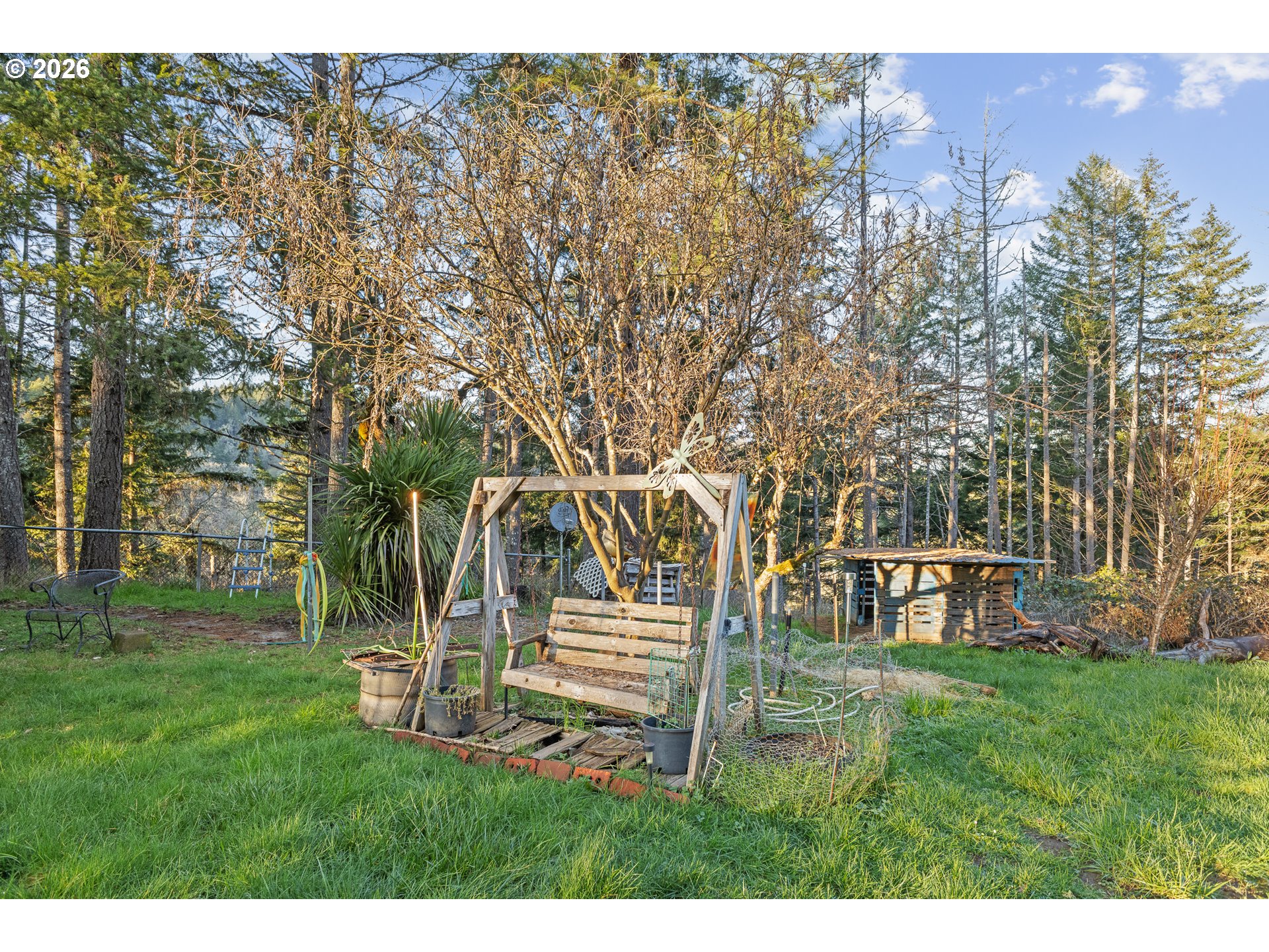 2409 Ireland Road Winston, OR 97496 - Photo 8 of 39 a backyard of a house with table and chairs