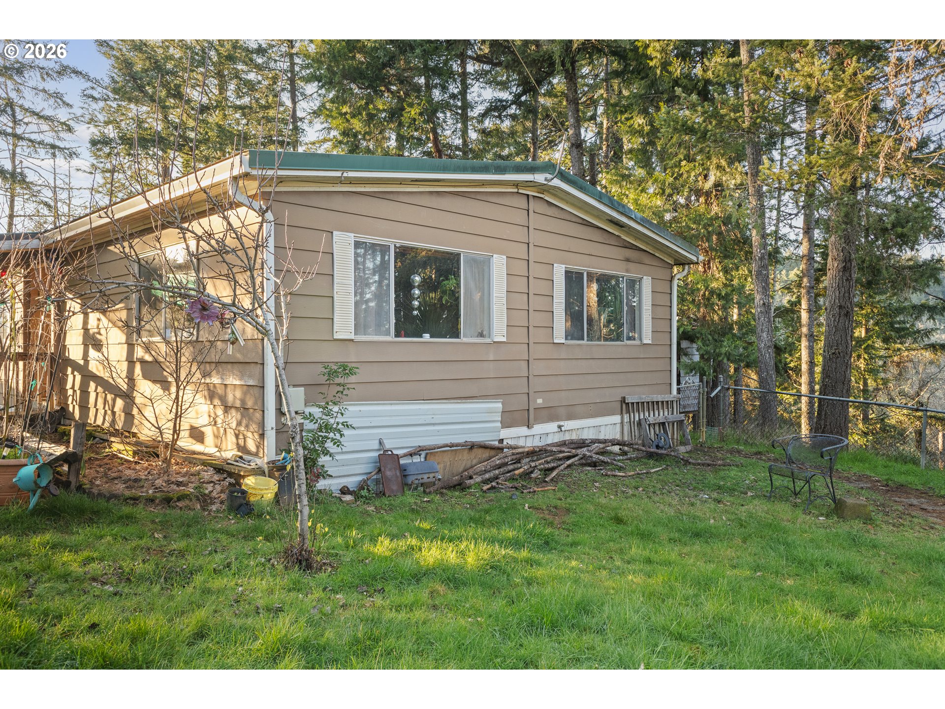 2409 Ireland Road Winston, OR 97496 - Photo 10 of 39 a backyard of a house with lots of green space