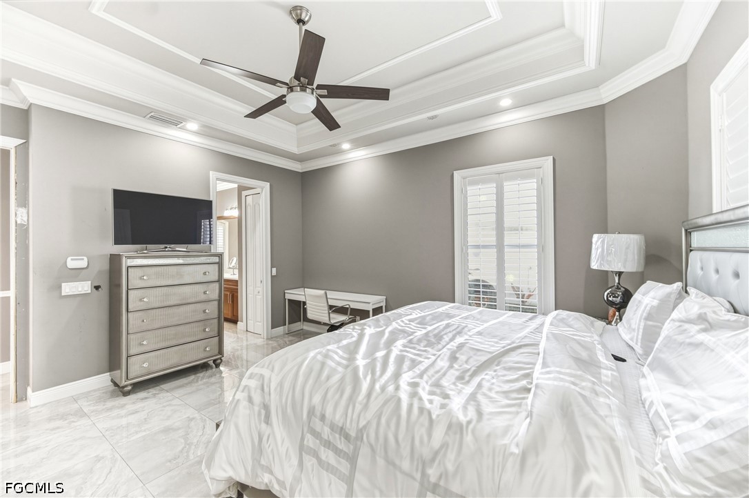 1700 43rd Terrace Southwest Naples, FL 34116 - Photo 18 of 38 a bedroom with a bed and a flat screen tv
