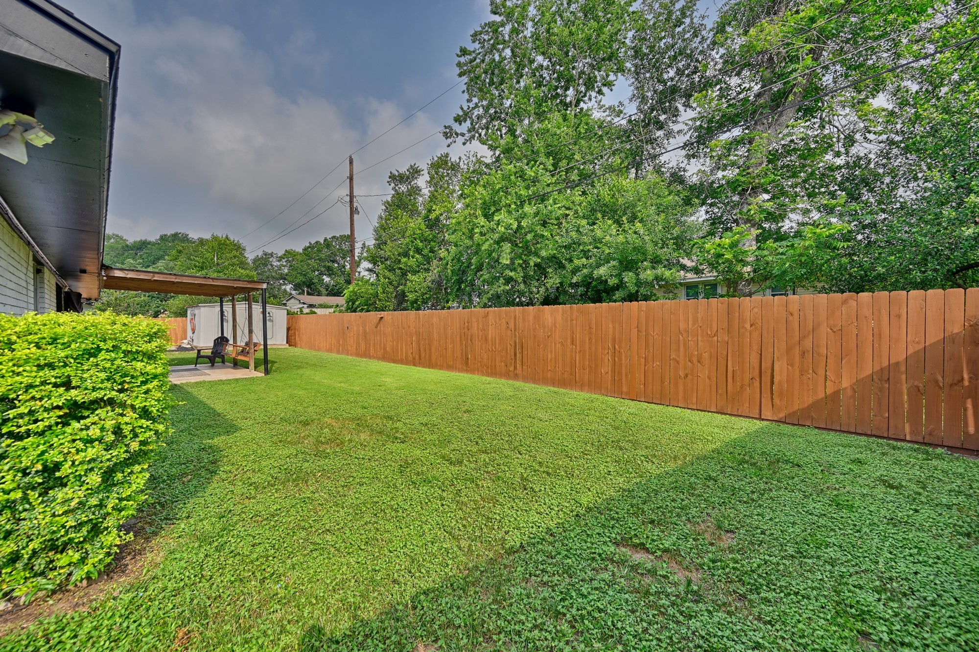 507 Sandra Drive Brenham, TX 77833 - Photo 17 of 30 a view of a backyard with a garden
