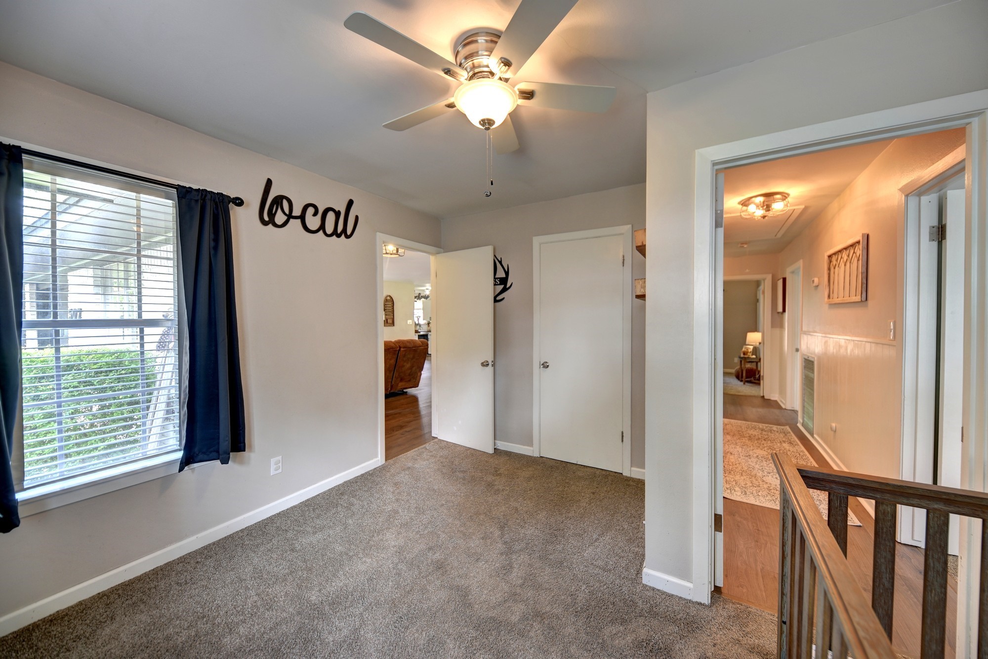 507 Sandra Drive Brenham, TX 77833 - Photo 21 of 30 a view of a hallway with a chandelier fan and windows