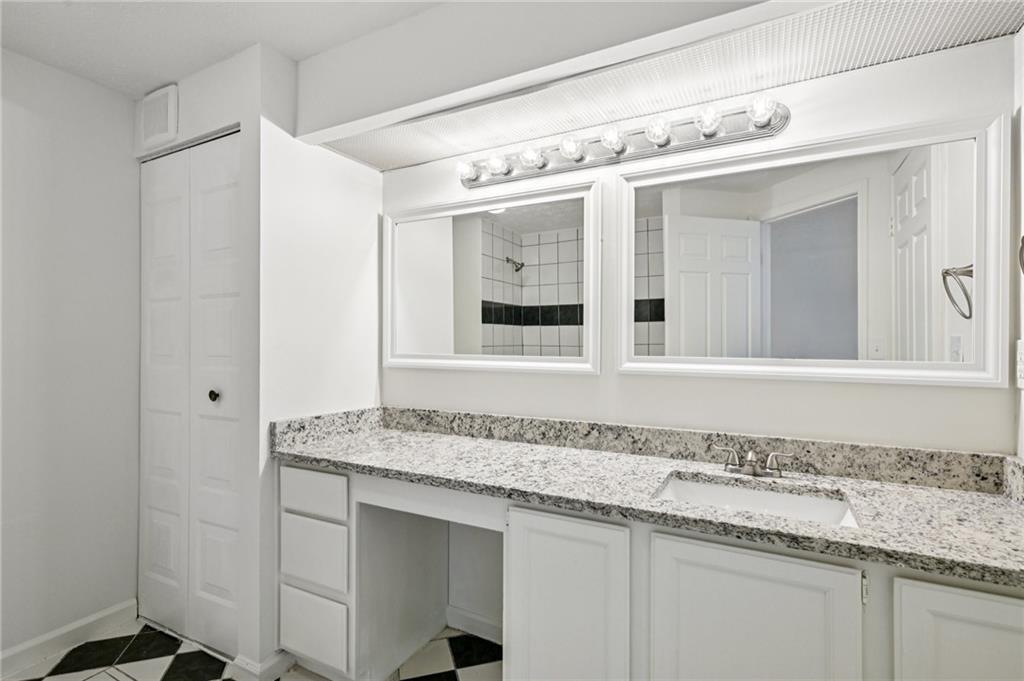 4263 Parkview Court Stone Mountain, GA 30083 - Photo 22 of 31 a bathroom with a sink and a mirror