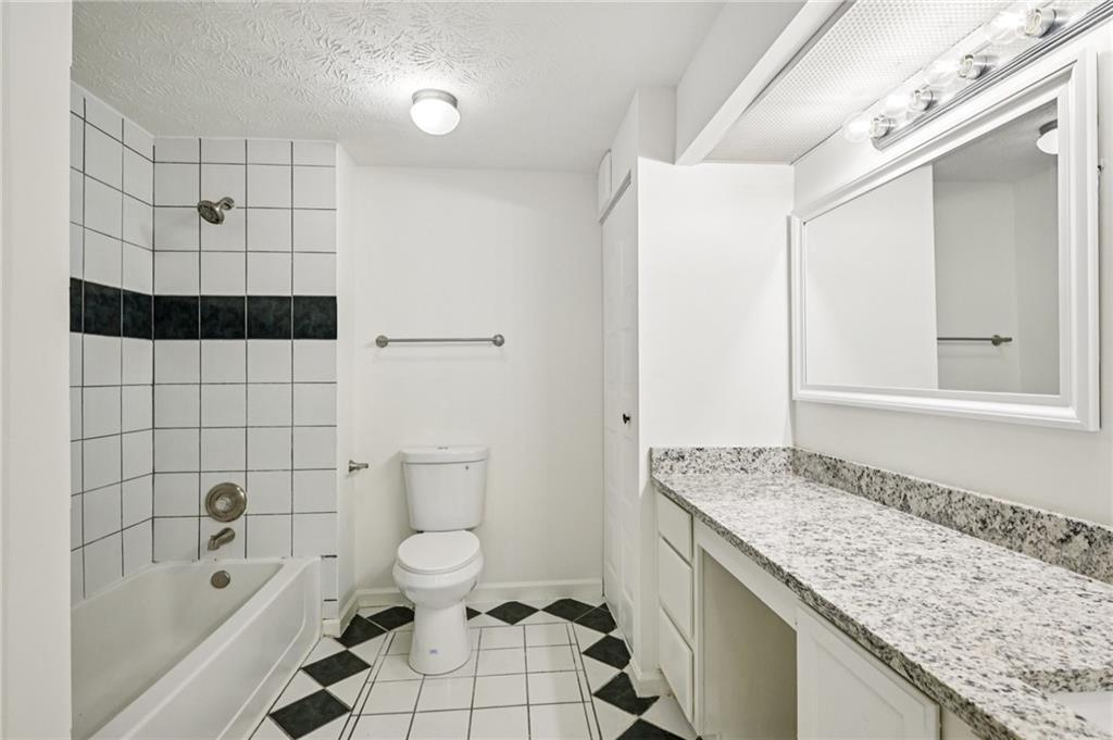 4263 Parkview Court Stone Mountain, GA 30083 - Photo 23 of 31 a bathroom with a granite countertop sink toilet and shower