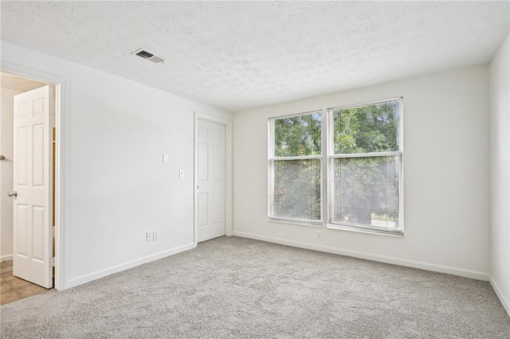 4263 Parkview Court Stone Mountain, GA 30083 - Photo 26 of 31 an empty room with windows