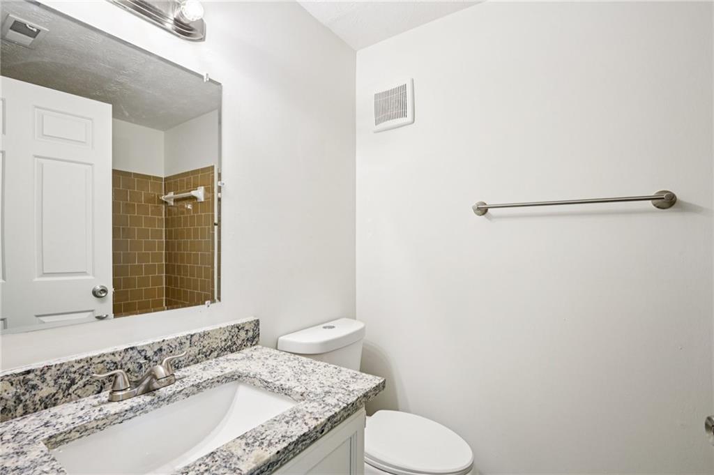 4263 Parkview Court Stone Mountain, GA 30083 - Photo 27 of 31 a bathroom with a granite countertop sink and a mirror