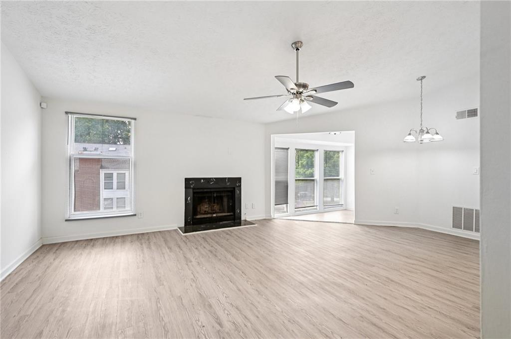 4263 Parkview Court Stone Mountain, GA 30083 - Photo 4 of 31 a view of an empty room with a window and wooden floor