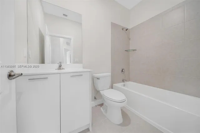 a bathroom with a toilet sink and shower