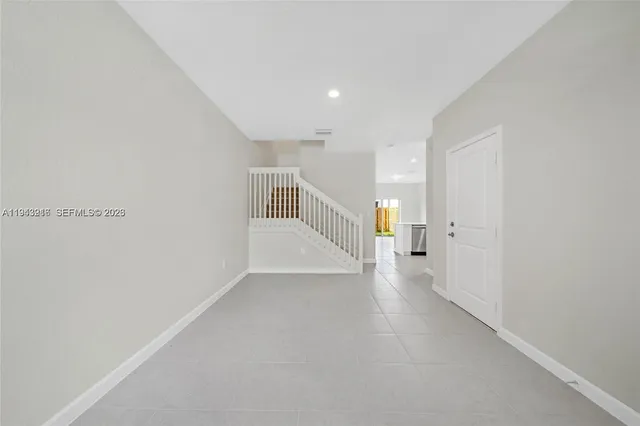 a view of a hallway with stairs