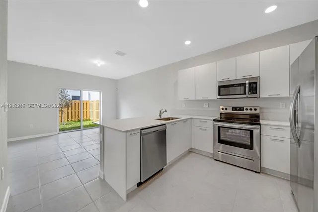 a kitchen with a stove a sink and a microwave