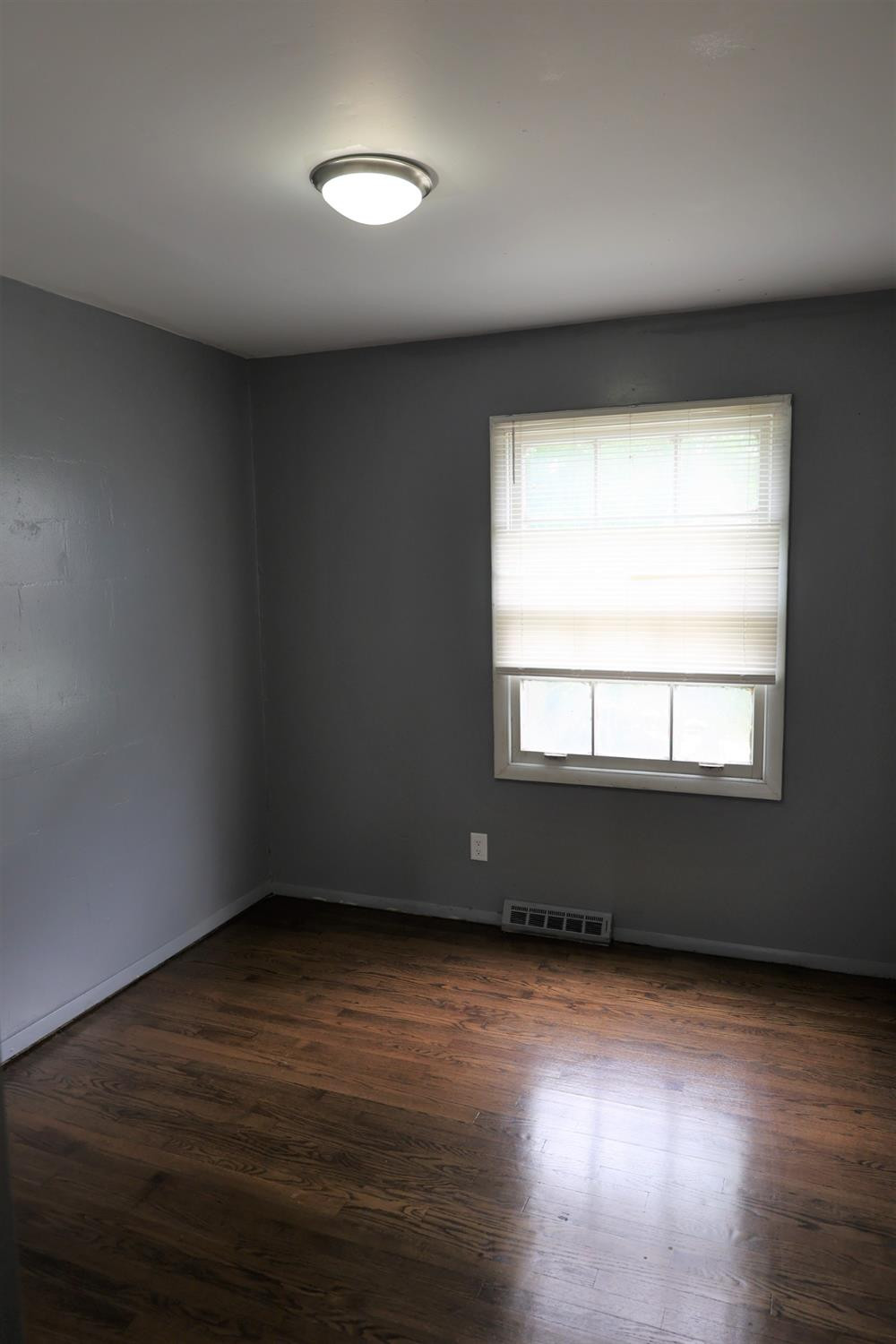 1543 Tennessee Street Gary, IN 46407 - Photo 12 of 22 an empty room with wooden floor and windows