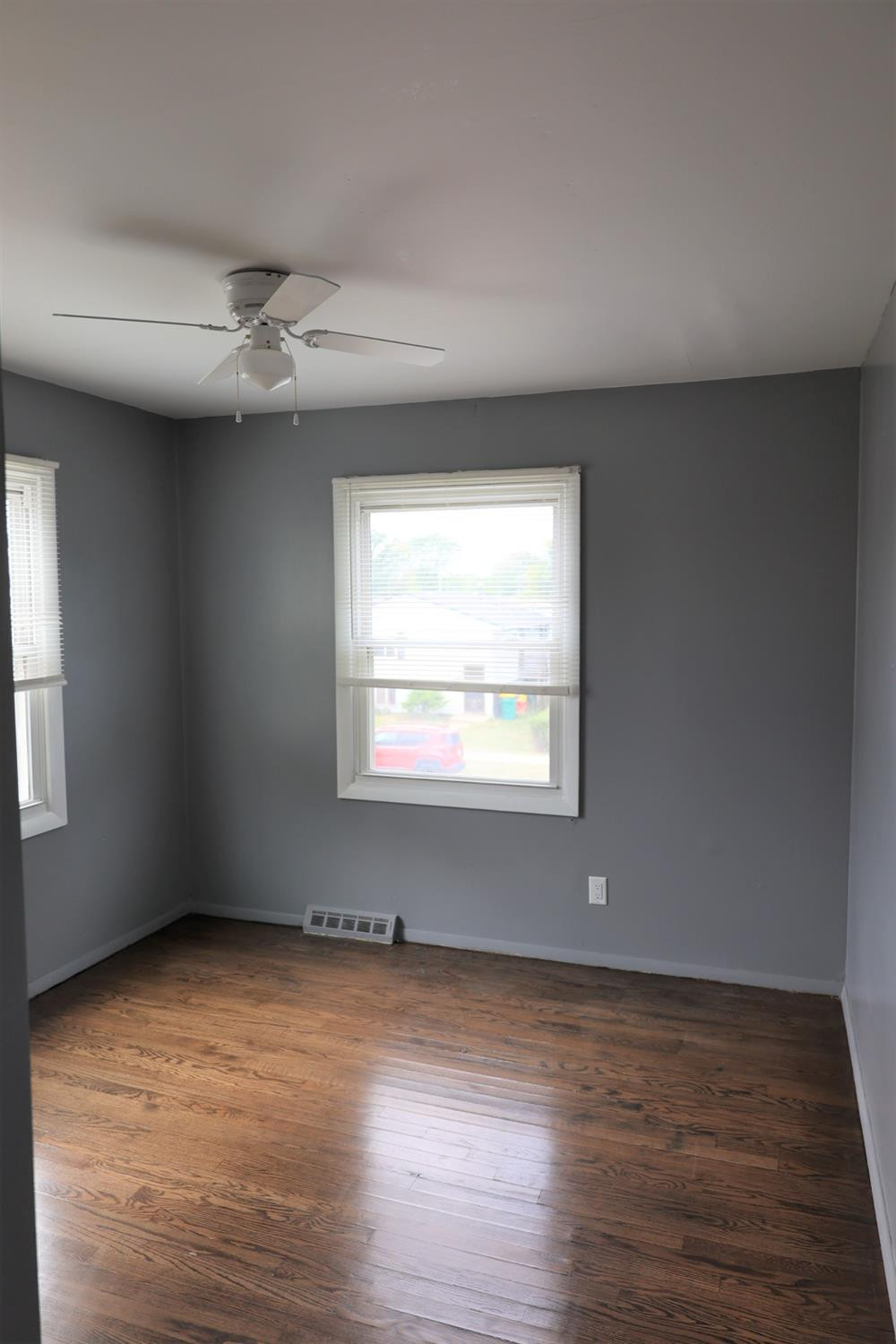 1543 Tennessee Street Gary, IN 46407 - Photo 13 of 22 an empty room with wooden floor ceiling fan and windows