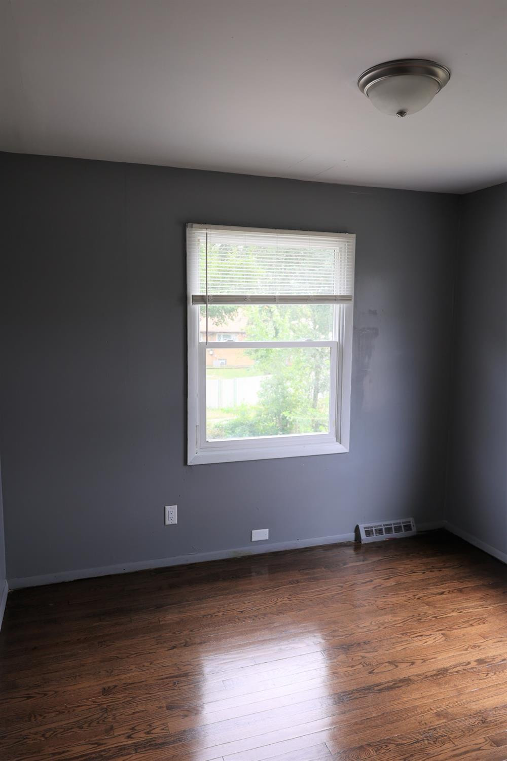 1543 Tennessee Street Gary, IN 46407 - Photo 15 of 22 an empty room with wooden floor and windows