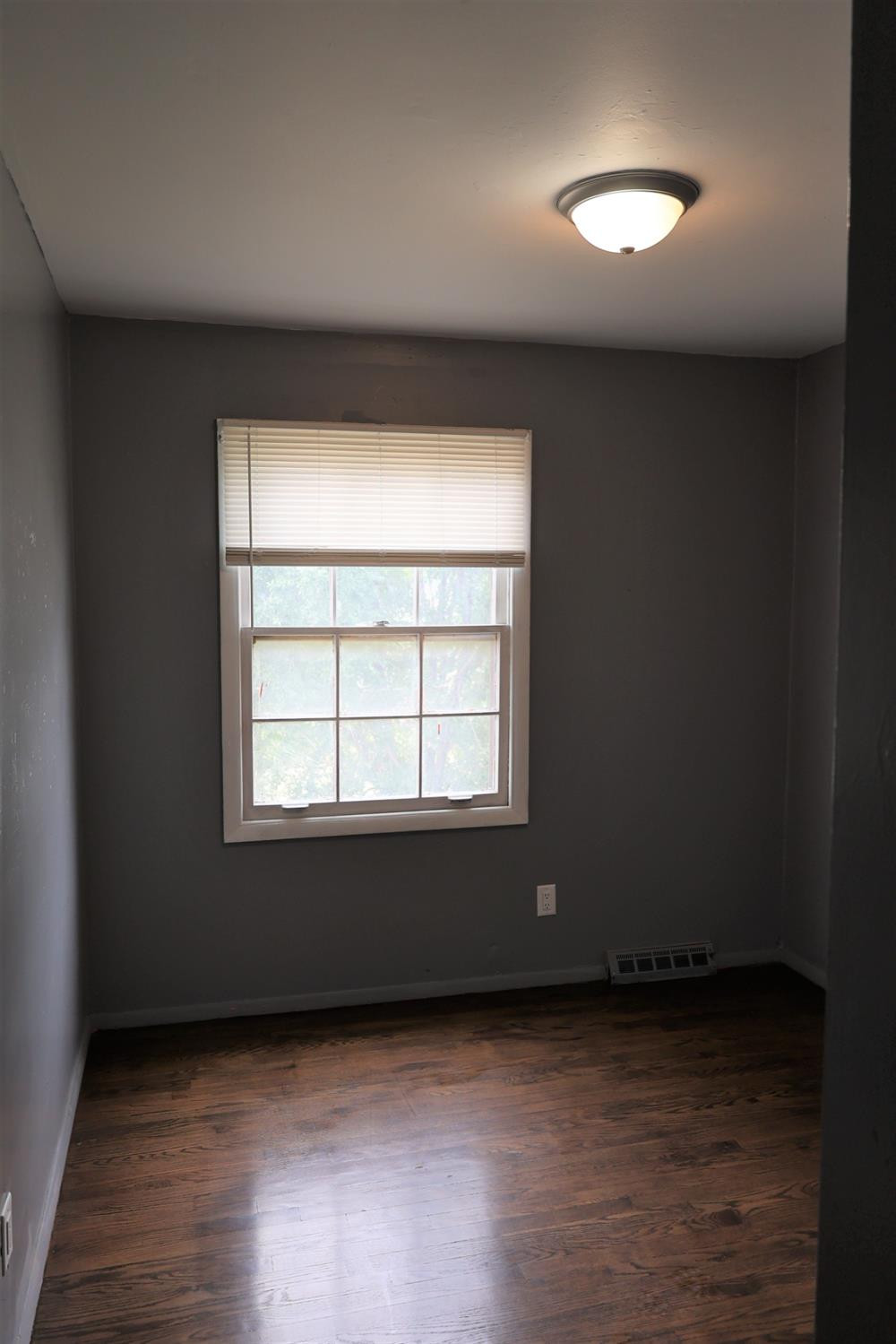 1543 Tennessee Street Gary, IN 46407 - Photo 17 of 22 an empty room with wooden floor and windows