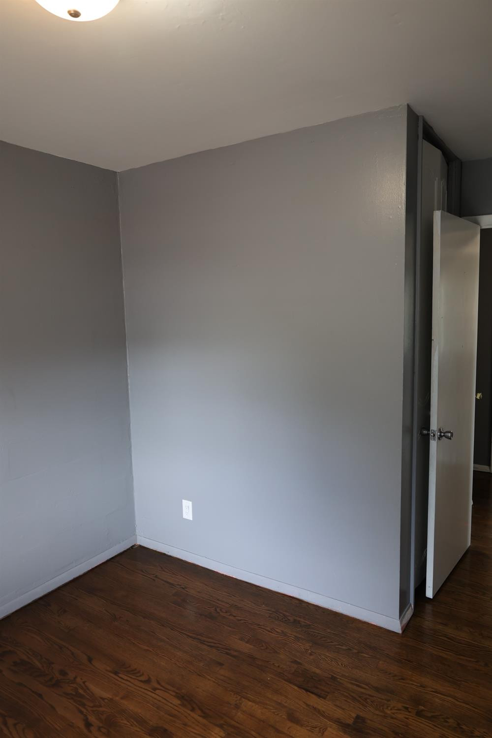1543 Tennessee Street Gary, IN 46407 - Photo 18 of 22 a view of an empty room with wooden floor and a window
