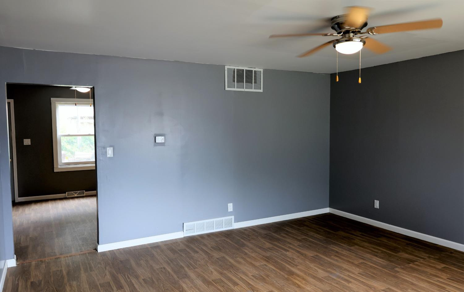 1543 Tennessee Street Gary, IN 46407 - Photo 4 of 22 a view of an empty room with window and wooden floor
