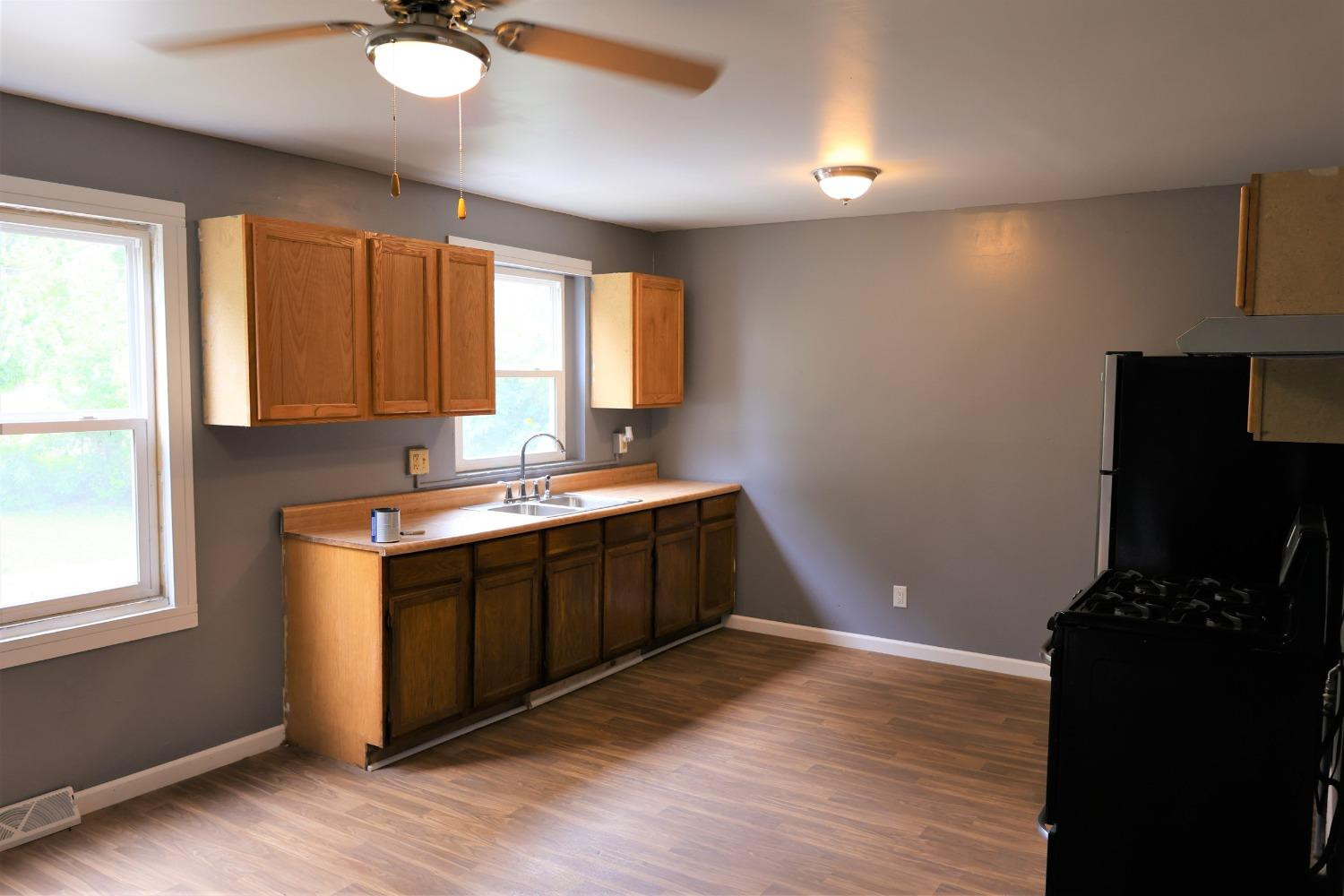 1543 Tennessee Street Gary, IN 46407 - Photo 6 of 22 a kitchen with a refrigerator and a stove top oven