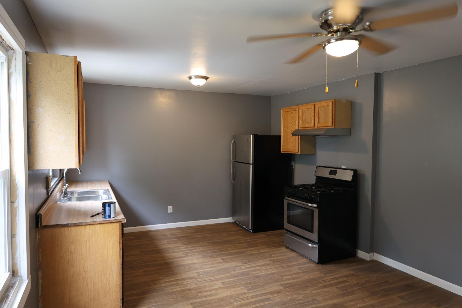 1543 Tennessee Street Gary, IN 46407 - Photo 7 of 22 a kitchen with stainless steel appliances granite countertop a refrigerator a stove and a microwave oven with wooden floor