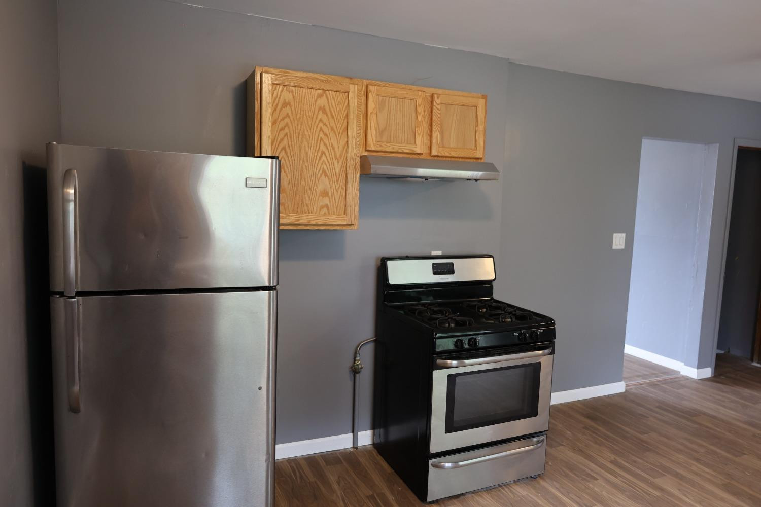 1543 Tennessee Street Gary, IN 46407 - Photo 8 of 22 a kitchen with a refrigerator and a stove top oven