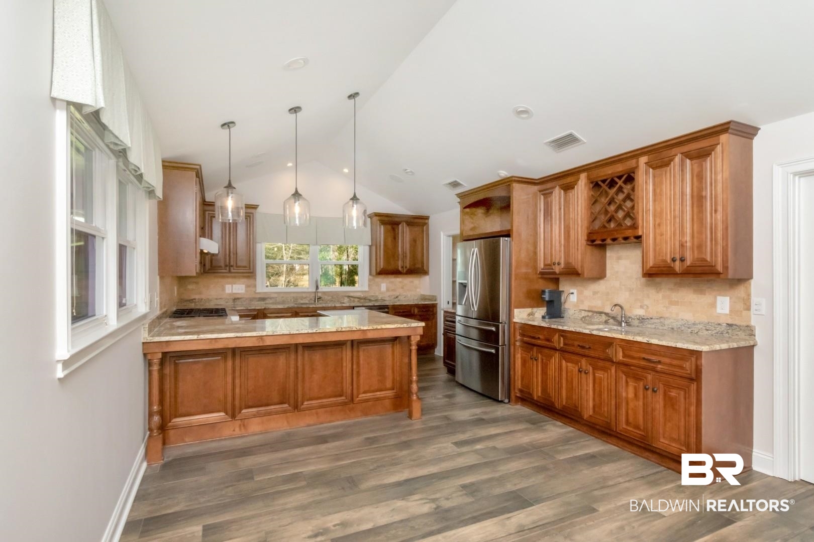 231 Rochester Road Mobile, AL 36608 - Photo 5 of 51 Kitchen with wood finish cabinetry, backsplash, a peninsula, and lofted ceiling