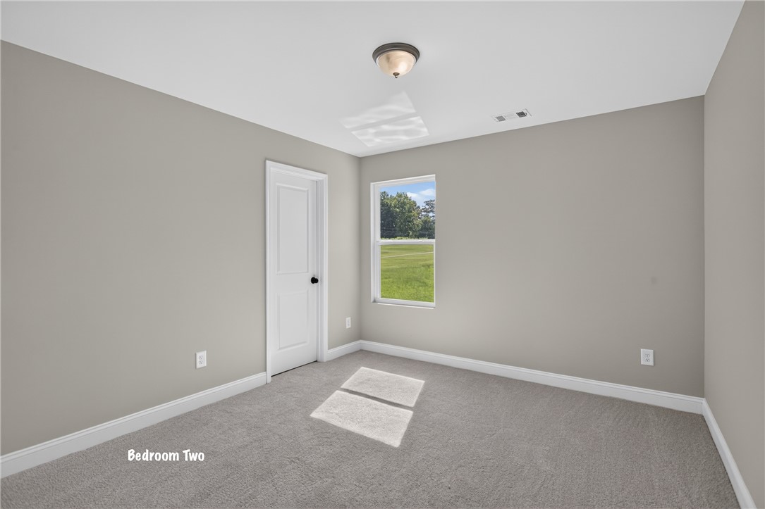 2007 Aberdeen Lane Walhalla, SC 29691 - Photo 23 of 41 A well-lit bedroom features plush carpeting and a bright window offering peaceful outdoor views.