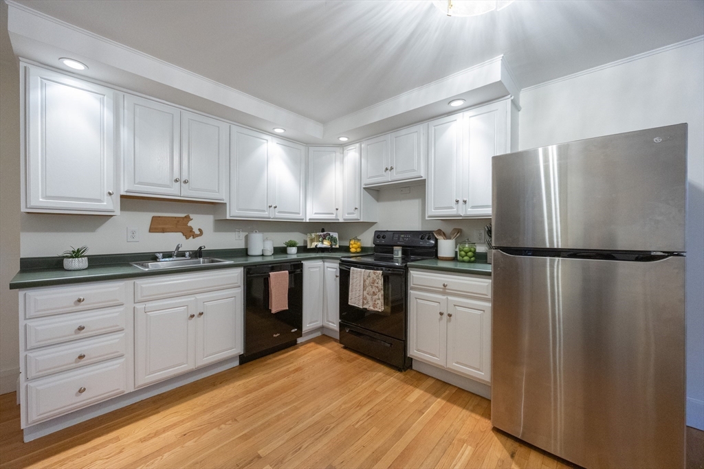 12 1st Street, Unit 12 Ipswich, MA 01938 - Photo 12 of 42 a kitchen with granite countertop stainless steel appliances a refrigerator a sink and cabinets