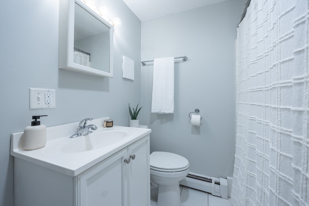 12 1st Street, Unit 12 Ipswich, MA 01938 - Photo 20 of 42 a bathroom with a sink a toilet and mirror