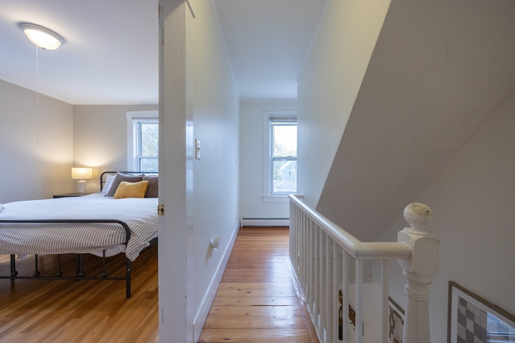 12 1st Street, Unit 12 Ipswich, MA 01938 - Photo 21 of 42 a view of a room with wooden floor and stairs