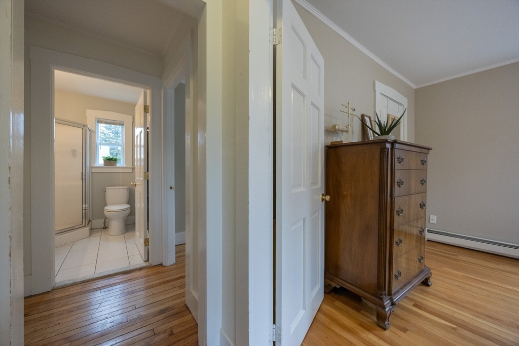 12 1st Street, Unit 12 Ipswich, MA 01938 - Photo 25 of 42 a view of a hallway with wooden floor and a bathroom