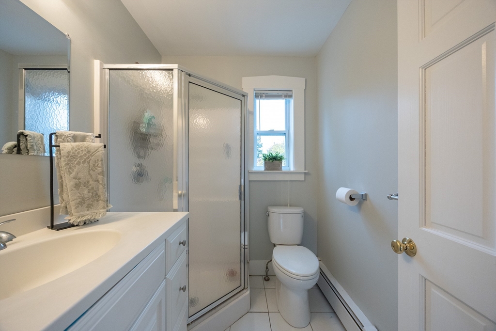 12 1st Street, Unit 12 Ipswich, MA 01938 - Photo 30 of 42 a bathroom with a granite countertop sink toilet and shower