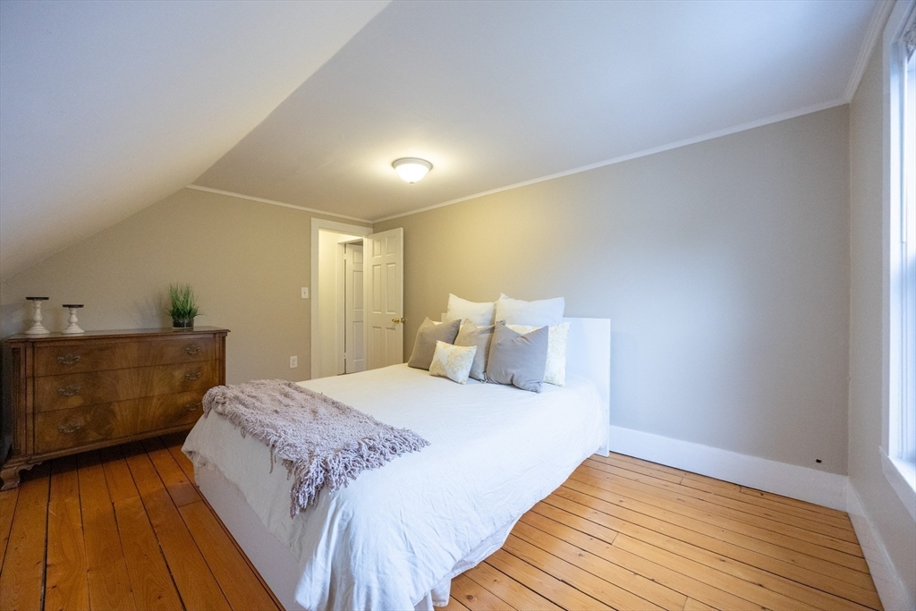 12 1st Street, Unit 12 Ipswich, MA 01938 - Photo 31 of 42 a bed room with a bed and a potted plant